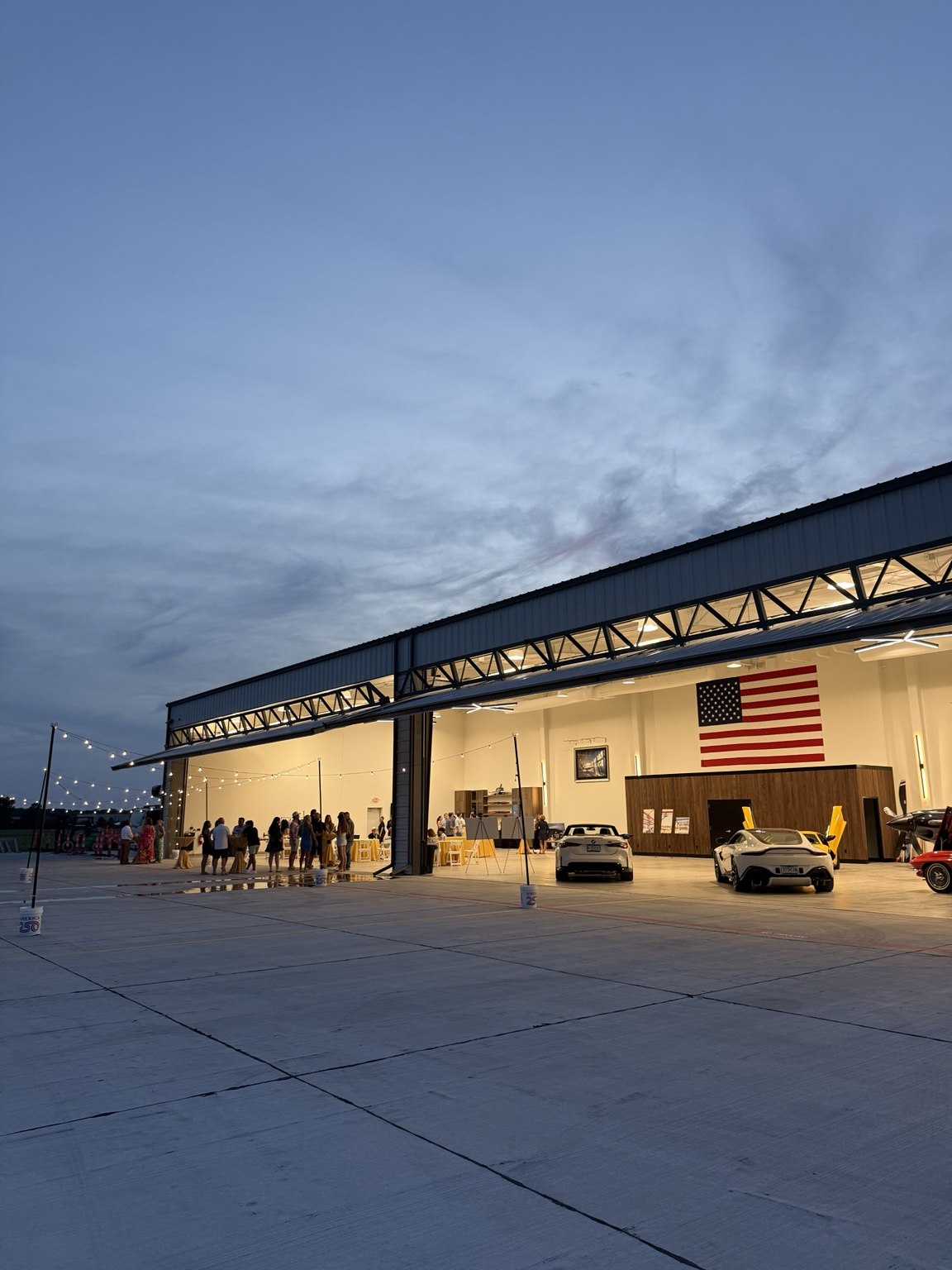 The illuminated hangars at dusk