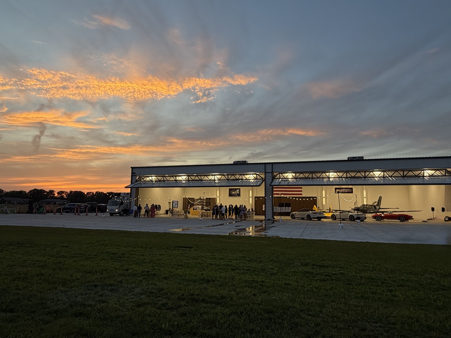 A colorful sunset over the open hangars