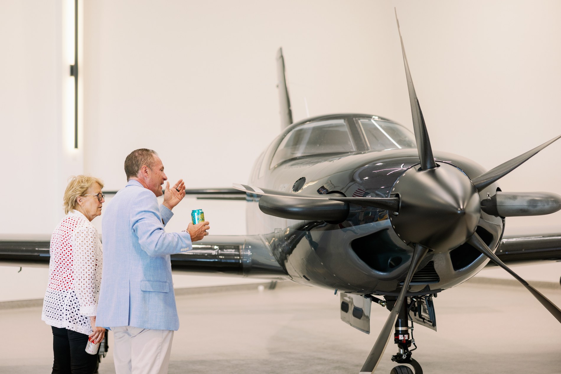 Guests beside a propeller aircraft